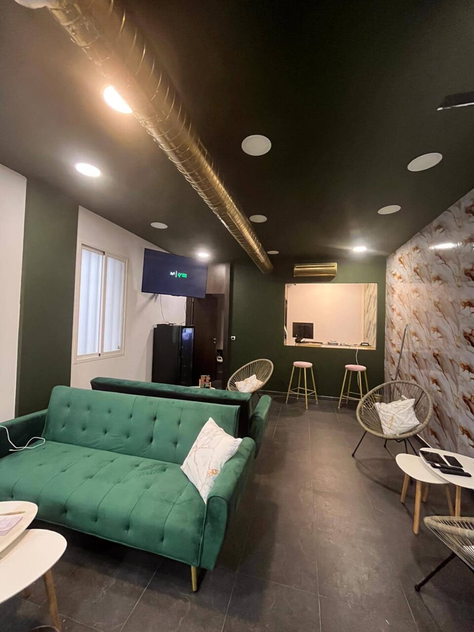 Основной зал каннабис-клуба Green Paradise в Мадриде с зелёными диванами